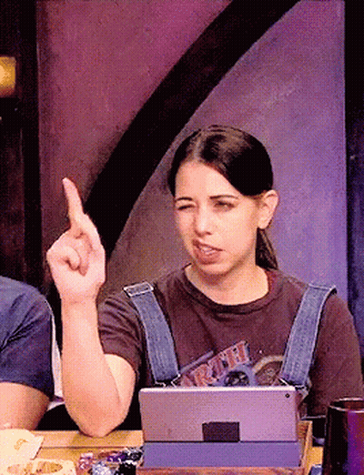 A Woman Sitting At A Table With A Tablet And A T-Shirt That Says ' Ariel ' On It GIF