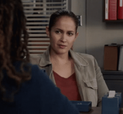 A Woman Sitting At A Table With A Tissue Box In Front Of Her GIF