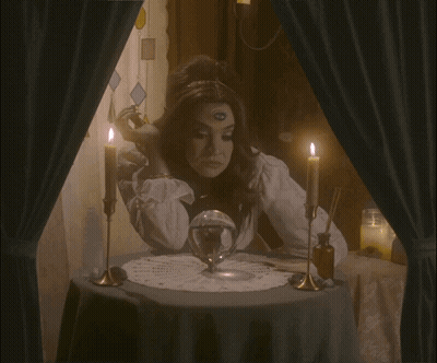 A Woman Sitting At A Table With Candles And The Words The Audacity GIF