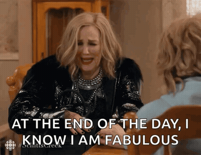 A Woman Sitting At A Table With The Words At The End Of The Day I Know I Am Fabulous In Front Of Her GIF