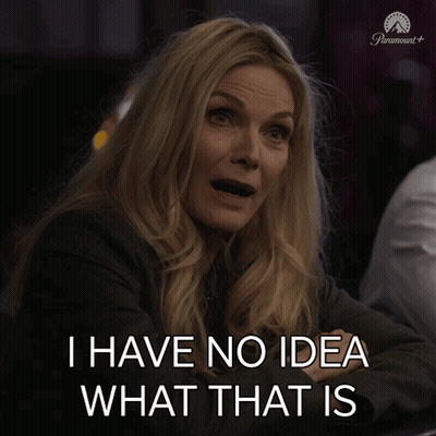 A Woman Sitting At A Table With The Words I Have No Idea What That Is Above Her GIF