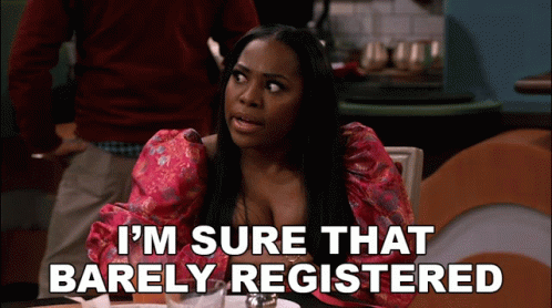 A Woman Sitting At A Table With The Words " I 'M Sure That Barely Registered " Below Her GIF