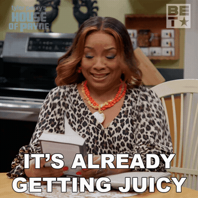 A Woman Sitting At A Table With The Words It 'S Already Getting Juicy On The Bottom GIF
