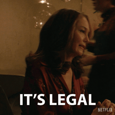 A Woman Sitting At A Table With The Words It 'S Legal On The Bottom GIF