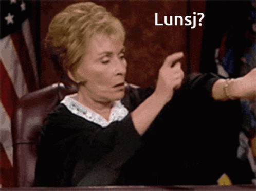 Woman Sitting At Table With Lunsj Sign GIF