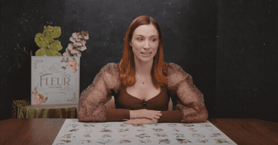 A Woman Sitting At A Table With The Words " No-One Is Complaining " Above Her GIF