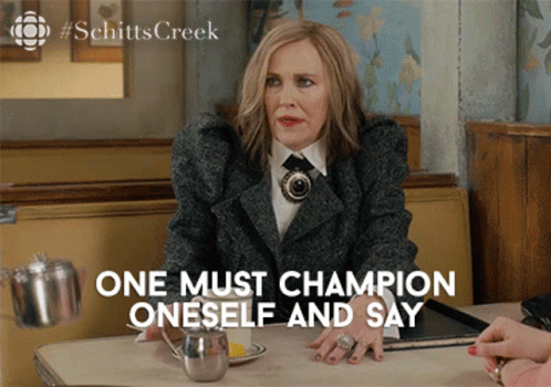 A Woman Sitting At A Table With The Words " One Must Champion Oneself And Say " GIF