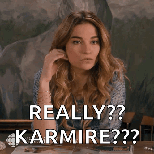 A Woman Sitting At A Table With The Words Really Karmire On The Screen GIF