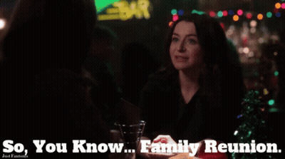 A Woman Sitting At A Table With The Words " So You Know Family Reunion " Above Her GIF