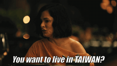A Woman Sitting At A Table With The Words " You Want To Live In Taiwan " GIF
