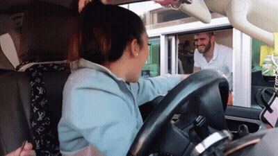 A Woman Sitting In A Car Talking To A Man GIF