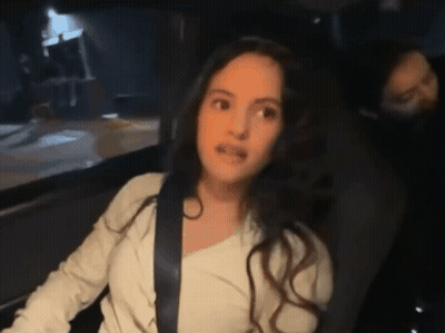 A Woman Sitting In A Car With A Seat Belt On GIF