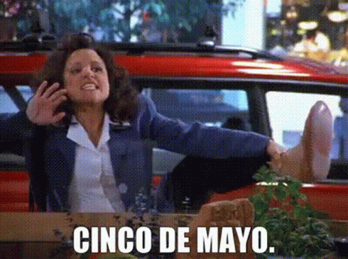 A Woman Sitting In A Car With Her Feet Up And The Words Cinco De Mayo GIF