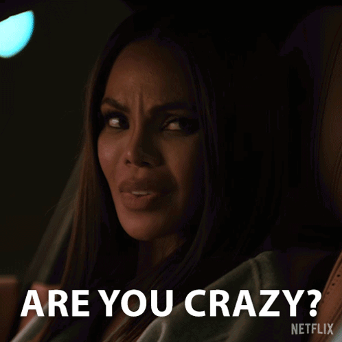 A Woman Sitting In A Car With The Words " Are You Crazy " On The Bottom GIF