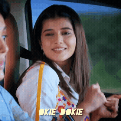 A Woman Sitting In A Car With The Words Okie Dokie On The Bottom Right GIF