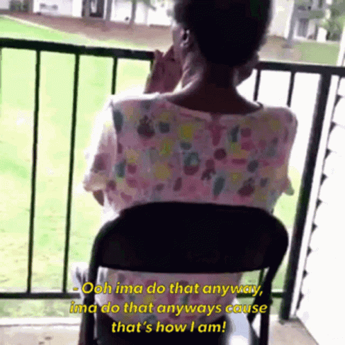 A Woman Sitting In A Chair On A Balcony Talking On Her Phone GIF