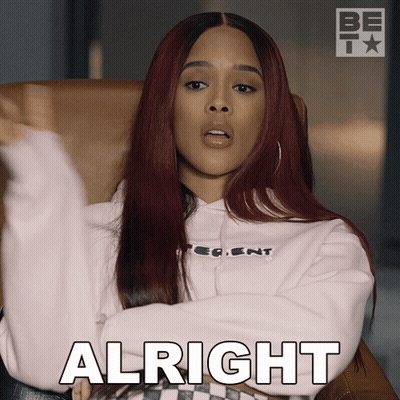 A Woman Sitting In A Chair Says Alright GIF