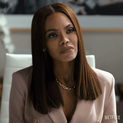 A Woman Sitting In A Chair With A Netflix Logo On The Bottom Left GIF