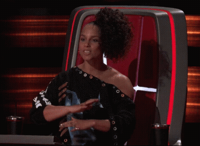 A Woman Sitting In A Chair With A Shirt That Says ' Ear ' On It GIF