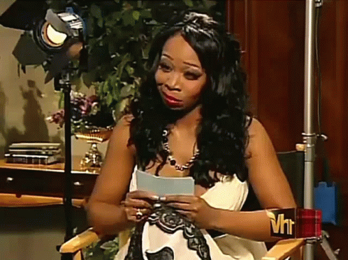 A Woman Sitting In A Chair With A Vh1 Sticker On Her Arm GIF