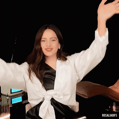 A Woman Sitting In A Chair With Her Arms Outstretched And The Hashtag Rosaliagifs GIF