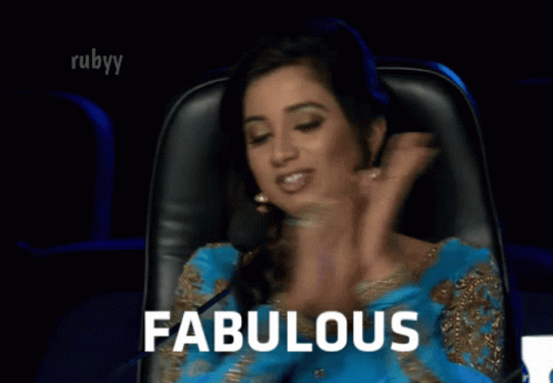A Woman Sitting In A Chair With The Word Fabulous Written On The Screen GIF