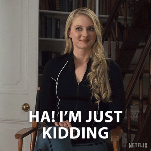 A Woman Sitting In A Chair With The Words " Ha I 'M Just Kidding " GIF
