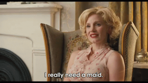 A Woman Sitting In A Chair With The Words I Really Need A Maid Below Her GIF
