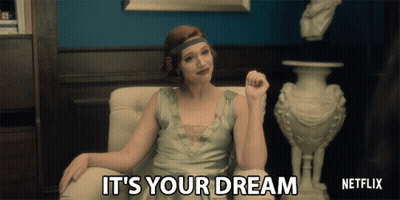A Woman Sitting In A Chair With The Words " It 'S Your Dream " Written On The Screen GIF