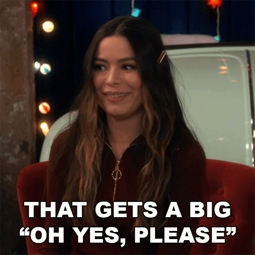 A Woman Sitting In A Chair With The Words " That Gets A Big Oh Yes Please " GIF