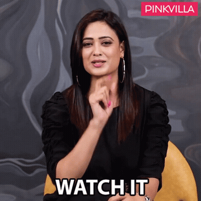 A Woman Sitting In A Chair With The Words Watch It Written On The Bottom GIF