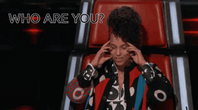 A Woman Sitting In A Chair With The Words " Who Are You " Written Above Her GIF