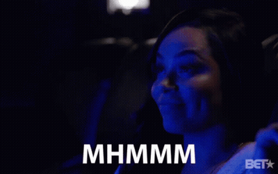 A Woman Sitting In A Dark Room With A Bet Logo On The Bottom Right GIF