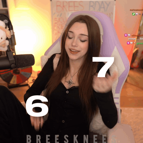 A Woman Sitting In A Purple Chair With The Number 6 And 7 On It GIF