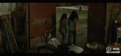 A Woman Sitting In A Red Car With Mobi Recorder Written On The Bottom Of The Screen GIF