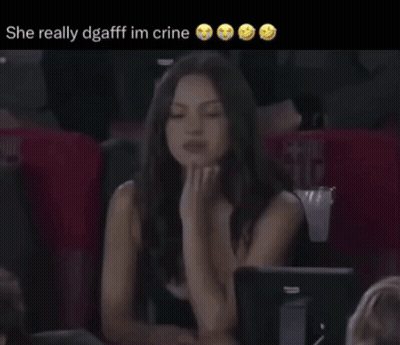 A Woman Sitting In A Stadium With The Words She Really Dgaff Im Crine Below Her GIF