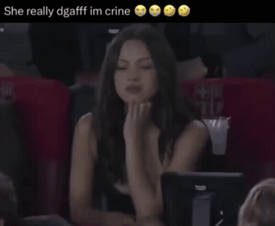 A Woman Sitting In A Stadium With The Words She Really Dgafff Im Crine GIF
