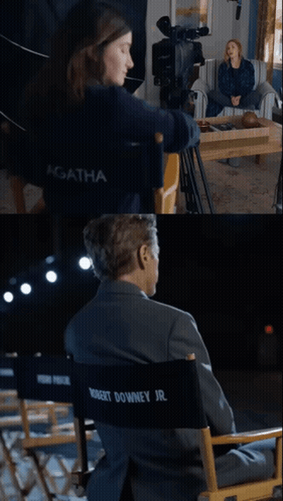 A Woman Sitting In Front Of A Camera And A Man In A Director 'S Chair GIF