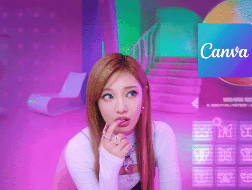 A Woman Sitting In Front Of A Canva Sign GIF