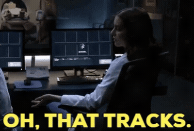 A Woman Sitting In Front Of A Computer With The Words Oh That Tracks On The Bottom GIF
