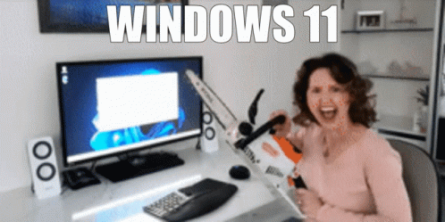 A Woman Sitting In Front Of A Computer With The Words Windows 11 Written On The Bottom GIF
