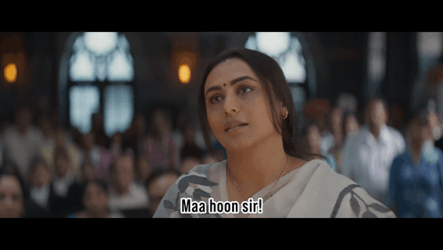 A Woman Sitting In Front Of A Crowd Says Maa Hoon Sir GIF