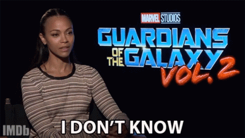 A Woman Sitting In Front Of A Guardians Of The Galaxy Vol 2 Sign GIF