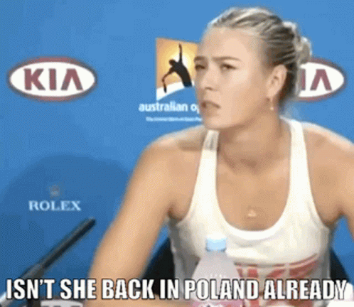 A Woman Sitting In Front Of A Kia And Rolex Banner GIF
