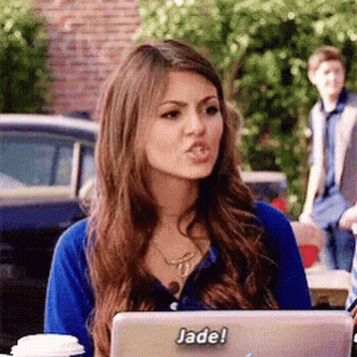 A Woman Sitting In Front Of A Laptop With A Sticker That Says Jade On It GIF
