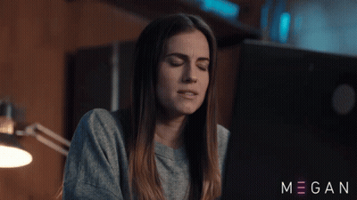 A Woman Sitting In Front Of A Laptop With The Name Megan On The Bottom Right GIF