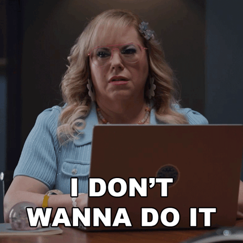 A Woman Sitting In Front Of A Laptop With The Words " I Don 'T Wanna Do It " GIF