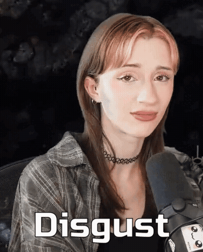 A Woman Sitting In Front Of A Microphone With The Word Disgust Written On The Bottom GIF