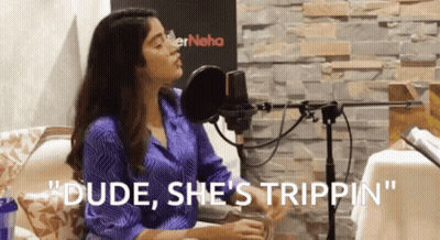 A Woman Sitting In Front Of A Microphone With The Words " Dude She 'S Trippin " GIF
