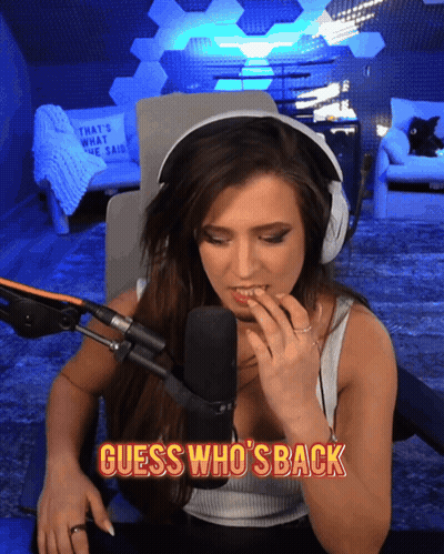 A Woman Sitting In Front Of A Microphone With The Words " Guess Who 'S Back " Below Her GIF